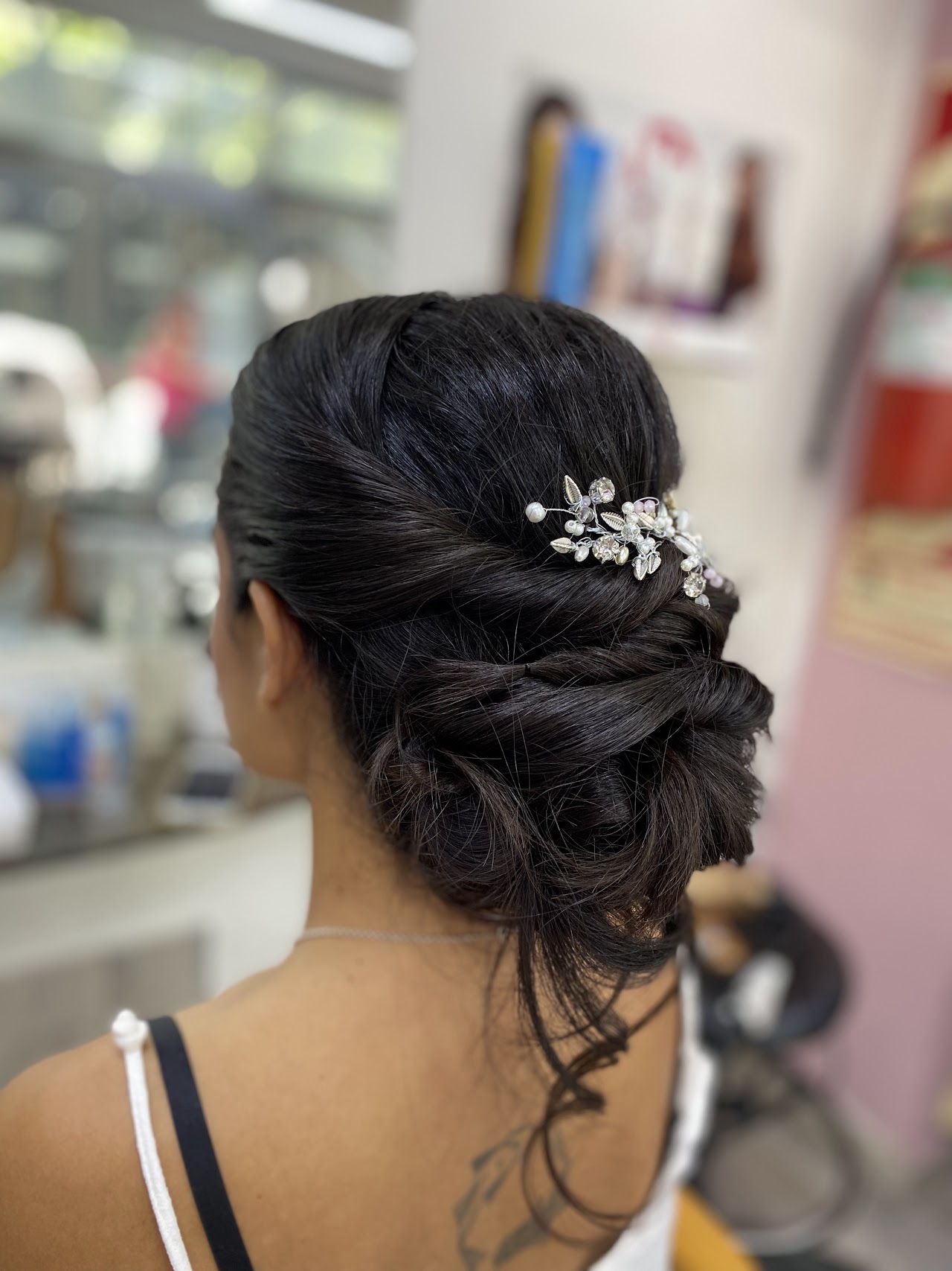 A before and after comparison showing a dramatic hair transformation. The 'before' image shows frizzy, dull hair, while the 'after' image reveals shiny, smooth, and perfectly curled brunette hair, illustrating the effectiveness of professional treatments and styling.